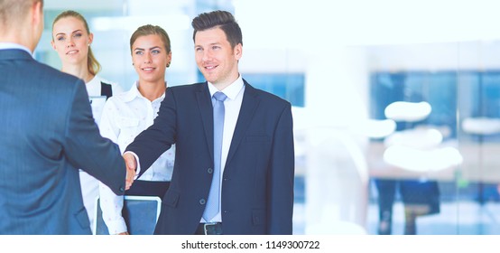 Full Length Image Of Two Successful Business Men Shaking Hands With Each Other