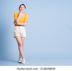 Full Length Image Of Young Asian Woman Posing On Blue Background