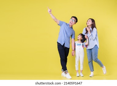 Full Length Image Of Young Asian Family On Background