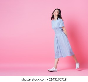Full length image of young Asian woman wearing blue dress on pink background - Shutterstock ID 2143170719