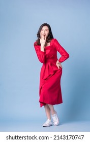 Full Length Image Of Young Asian Woman Wearing Red Dress On Blue Background