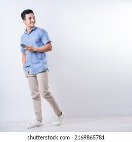 Full Length Image Of Young Asian Man On White Background