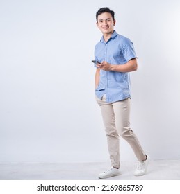 Full length image of young Asian man on white background - Shutterstock ID 2169865789