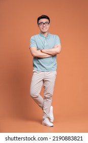 Full Length Image Of Young Asian Man Standing On Backgound