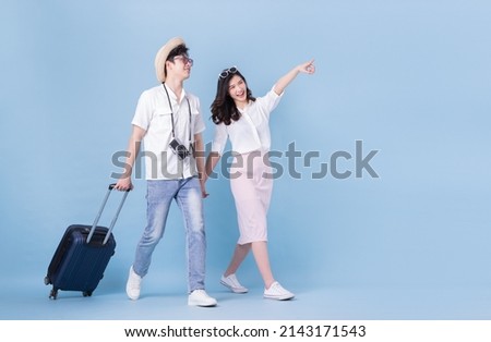 Full length image of young Asian couple travel, summer vacation