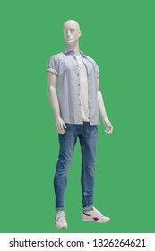 Full length male mannequin dressed in casual clothes, isolated on a green background. No brand names or copyright objects.