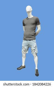 Full Length Male Mannequin Dressed In Summer Knitted Short Sleeve Sweater, Isolated On Blue Background. No Brand Names Or Copyright Objects.