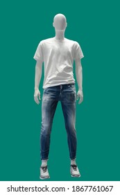 Full length male mannequin dressed in t- shirt and blue ripped jeans, isolated on a green background. No brand names or copyright objects.