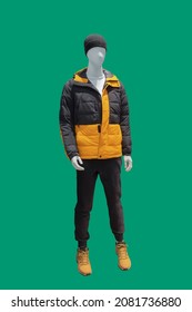 Full Length Male Mannequin Dressed In Warm Padded Jacket, Isolated On A Green Background