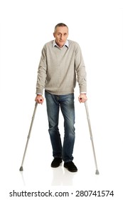 Full Length Mature Man With Crutches.