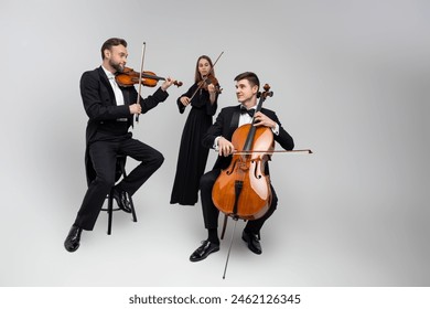 Full length of musicians playing cello and violins - Powered by Shutterstock