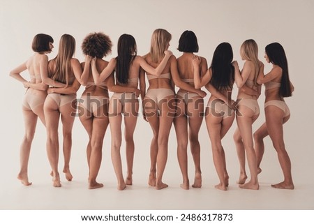 Full length no filter studio photo of attractive slim women wear lingerie hugging loving themselves isolated beige color wall background