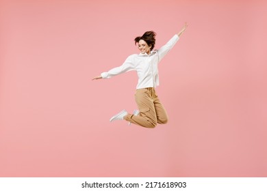 Full Length Overjoyed Young Successful Employee Business Woman Corporate Lawyer In Classic Formal White Shirt Work In Office Jump High With Outstretched Hands Fly Isolated On Pastel Pink Background.