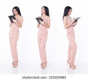 Full Length person of young adult woman stand confident and happy, white background isolated. Asian female smile cheerful in casual attire professional business executive look digital tablet.