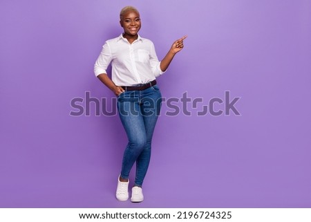 Full length photo of adorable cute lady wear smart casual look pointing empty space isolated purple color background