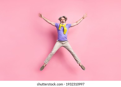 Full length photo of aged man jump up have fun excited star tied sweater isolated over pastel color background