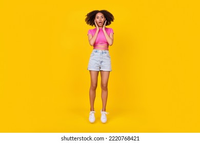 Full Length Photo Of Astonished Confused Person Jump Hands Touch Cheeks Isolated On Yellow Color Background