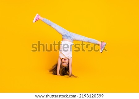 Similar – Woman doing a handstand on the beach