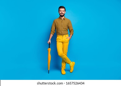 Full length photo of candid imposing man rest relax have vivid protect shield rainstorm parasol wear modern clothes shoes isolated over blue color background - Powered by Shutterstock