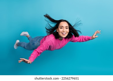 Full length photo of carefree adorable lady wear pink pullover arms wings flying air isolated blue color background - Shutterstock ID 2256279651