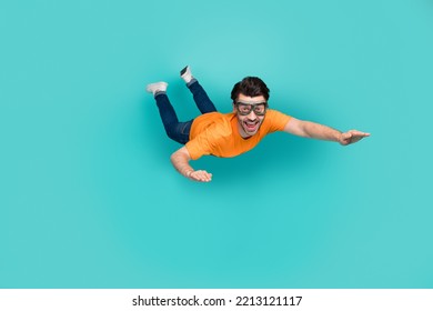 Full length photo of carefree sporty guy trying skydive falling down isolated on cyan color background