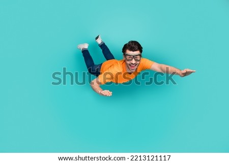 Full length photo of carefree sporty guy trying skydive falling down isolated on cyan color background