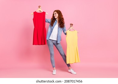 Full length photo of charming happy positive young woman hold hands dress choose isolated on pink color background