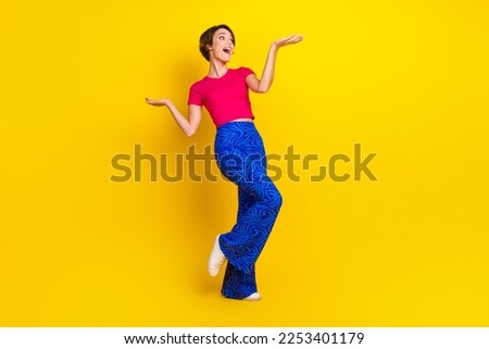 Full length photo of charming pretty lady wear stylish clothes cool offer compare products empty space isolated on yellow color background