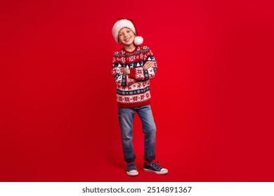 Full length photo of charming small boy crossed hands confident celebrate christmas dressed knitted sweater isolated on red background - Powered by Shutterstock