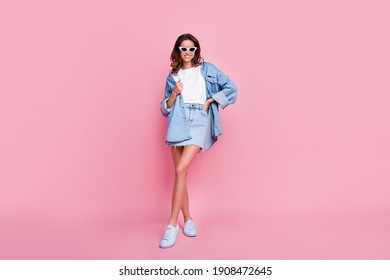 Full length photo of charming wavy young woman wear denim outfit dark glasses arm hand waist isolated pink color background - Powered by Shutterstock