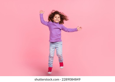 Full length photo of cheerful funky small kid wear violet sweater jumping high isolated pink color background - Powered by Shutterstock