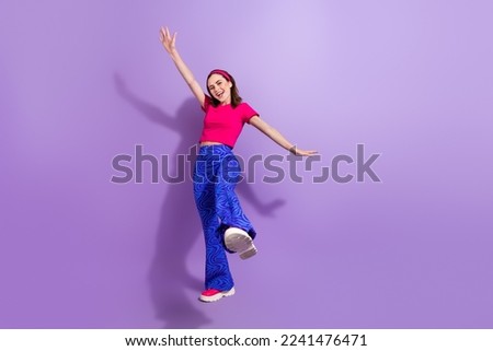Full length photo of cheerful glad lady wear trendy clothes rejoice win contest empty space isolated on purple color background