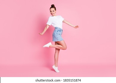 Full length photo of cheerful lovely girl enjoy rejoice weekend rest relax wear good mood, look clothes gumshoes isolated over pink color background