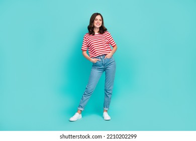 Full length photo of cheerful nice cute lady arm hand pocket dressed striped clothes denim white shoes isolated on cyan color background - Shutterstock ID 2210202299