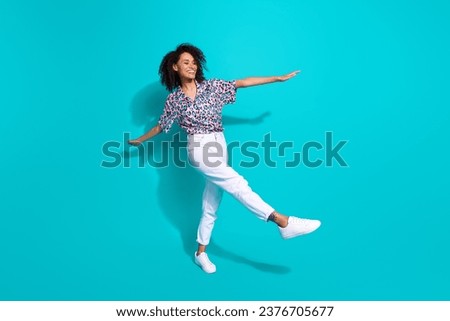 Full length photo of cheerful optimistic girl going walking enjoying weekend free time isolated on cyan color background