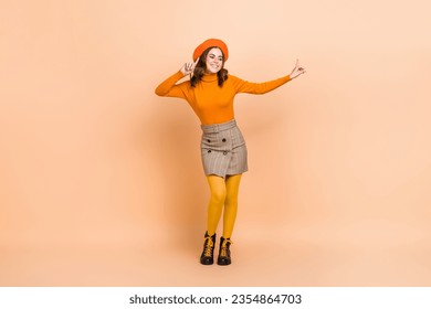Full length photo of cheerful positive lady wear stylish orange outfit rejoice low prices store center isolated on beige color background - Shutterstock ID 2354864703