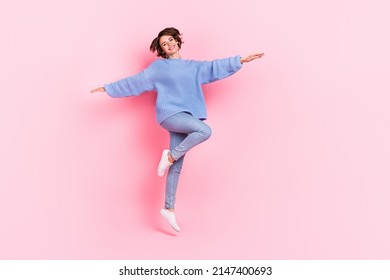 Full length photo of cheerful pretty person hands flight toothy smile isolated on pink color background - Shutterstock ID 2147400693