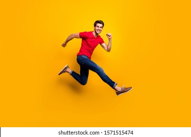 Full length photo of cheerful youth guy jump have fun on spring time holidays wear casual style clothing isolated over yellow color background