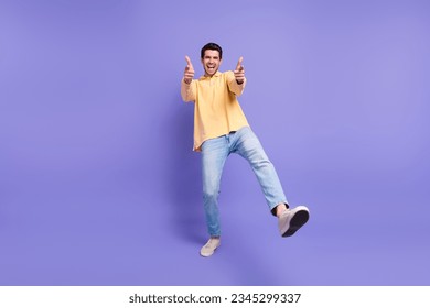 Full length photo of confident funky man dressed yellow shirt pointing two fingers you isolated purple color background - Powered by Shutterstock