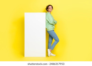 Full length photo of cool confident girl dressed green sweatshirt arms crossed modern device empty space isolated yellow color background - Powered by Shutterstock