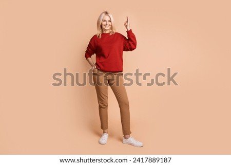 Full length photo of cool confident lady dressed red pullover showing okey gesture isolated beige color background