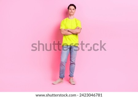 Full length photo of cool confident man dressed yellow t-shirt arms crossed empty space isolated pink color background
