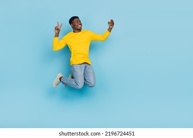 Full Length Photo Of Cool Millennial Brunet Guy Jump Do Selfie Wear Smart Casual Isolated On Blue Background