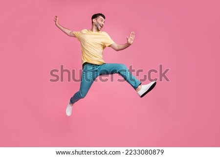 Full length photo of crazy optimistic man sportsman participate sport contest champion look empty space isolated on pink color background