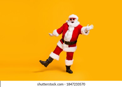 Full length photo of crazy santa claus with grey beard listen jolly holly music headset dance x-mas christmas party wear sunglass cap isolated bright shine color background