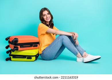 Full length photo of cute adorable girl dressed yellow t-shirt sitting floor packing luggage isolated teal color background - Shutterstock ID 2211163319