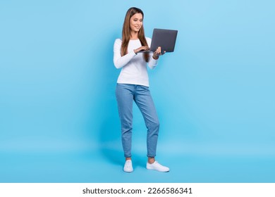 Full length photo of cute adorable woman wear white shirt typing email modern gadget isolated blue color background - Shutterstock ID 2266586341
