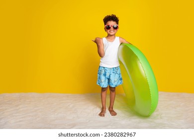 Full length photo of cute little boy dressed white shirt dark spectacles walking swimming thumb empty space isolated yellow color background - Powered by Shutterstock