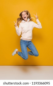 Full Length Photo Of Cute School Girl With Dental Braces Jumping And Showing Peace Sign Isolated Over Yellow Background