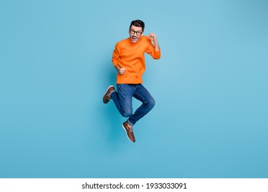 Full Length Photo Of Delighted Person Jump High Fists Unbelievable Achievement Isolated On Blue Color Background